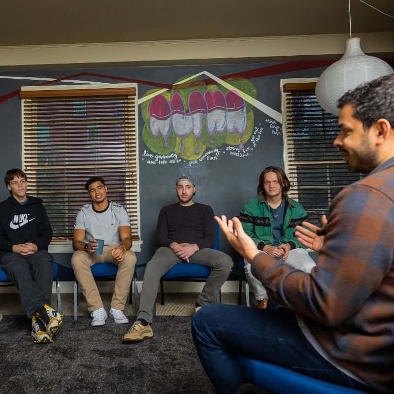 Young adult men in a group therapy setting at an Austin outpatient addiction treatment center